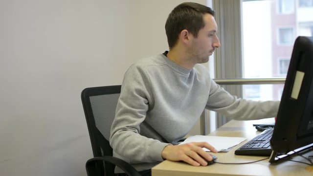 Frustrated office worker throwing business paper away