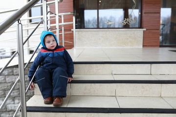 Boy resting on stairs