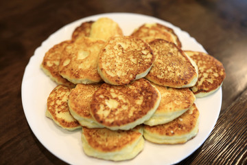 Obraz na płótnie Canvas Cottage cheese pancakes on white plate