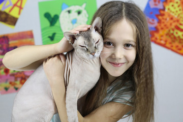 little girl playing with cat, baby and Sphinx