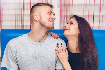 The concept of family conflict, problems, relationships of young disgruntled husband and wife in a room on the sofa.