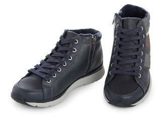 Pair of dark blue sporty sneakers, gumshoes for boy isolated on a white background, close up.