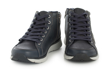 Pair of dark blue sporty sneakers, gumshoes for boy isolated on a white background, close up.