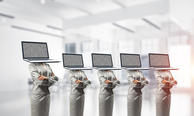 Business women with laptops instead of head.