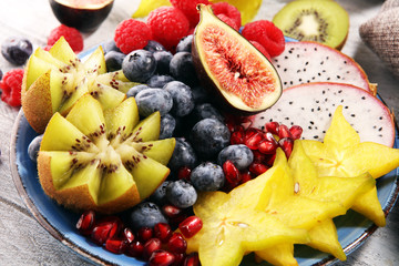 fruit bowl. Bowl of healthy fresh fruit salad on rustic background