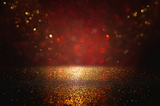 Red, black and gold glitter lights background. defocused.