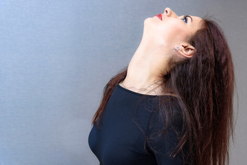 Fototapeta premium Studio portrait concept of a smiling beautiful brunette girl talking on a white background.