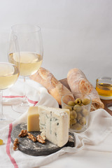 White wine in fine glass with cheese, grape and bread