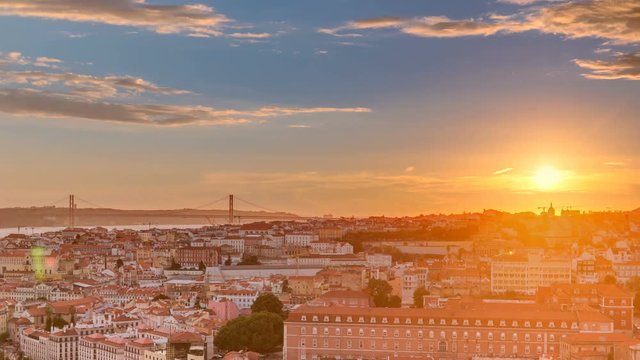 Lisbon at sunset aerial panorama view of city centre with red roofs at Autumn evening timelapse, Portugal