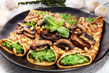 Savory Homemade Mushroom and Spinach Crepes with Cheese and avocado.