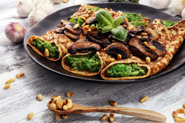 Savory Homemade Mushroom and Spinach Crepes with Cheese and avocado.
