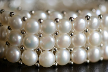 White pearl necklace on a dark background close up