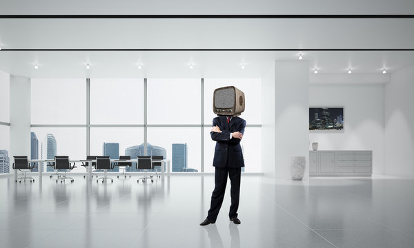 Businessman with an old TV instead of head.