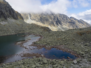 Panorama from Bystra lavka 2300m with the mountain lake Capie and in Mlynicka dolina and peak Strbsky stit 2381m , slovakian high Tatra mountains. fog and dramatic light © Kristyna