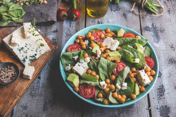 Healthy vegan salad with avocado , beet leaves ,chickpeas, broccoli ,tomato, cheese