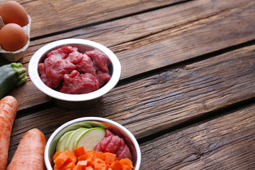 Composition with healthy dog food on wooden background. Space for text