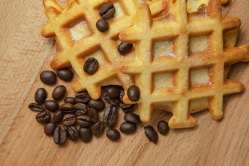 Tasty fresh Vienna wafers, grain coffee on a wooden background, close-up