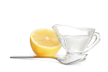 Composition with vinegar, lemon and baking soda on white background