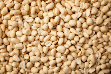 Dry shelled peanuts as background, top view. Healthy snack