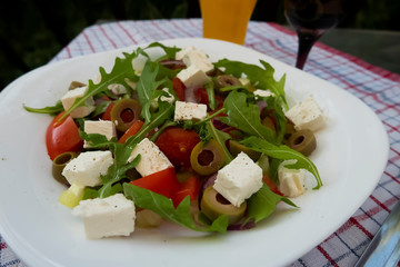 Greek salad on white plate.