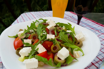 Greek salad on white plate.