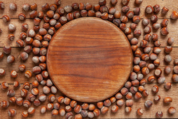 Close-up of a lot of hazelnuts on vintage wooden background. Top view, background.