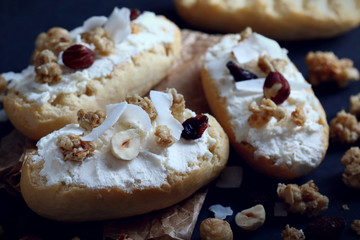 Bruschetta with ricotta cheese and granola cereals over dark blue background