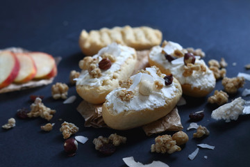 Bruschetta with ricotta cheese and granola cereals over dark blue background