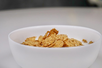 Cornflakes with milk on a white background