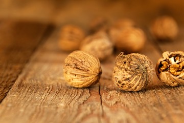 Walnuts on an old wooden table. Healthy Nuts. Blurred background. Vegetarian food.