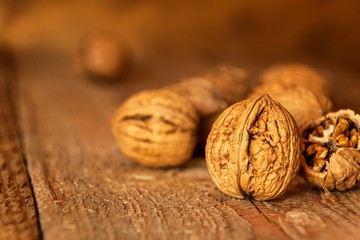 Walnuts on an old wooden table. Healthy Nuts. Blurred background. Vegetarian food.