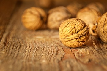 Walnuts on an old wooden table. Healthy Nuts. Blurred background. Vegetarian food.