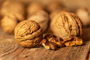 Walnuts on an old wooden table. Healthy Nuts. Blurred background. Vegetarian food.