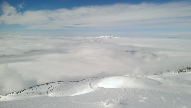 Snowy mountains over the clouds