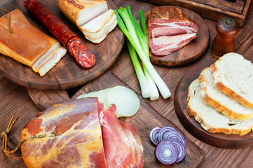 Smoked ham and bacon on wooden table