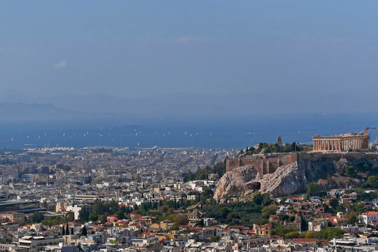 Greece, Athens cityscape with acropolis and saronic gulf as distant background
