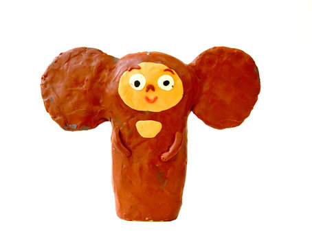 Plasticine figure the Cheburashka on a white background. Children's creativity