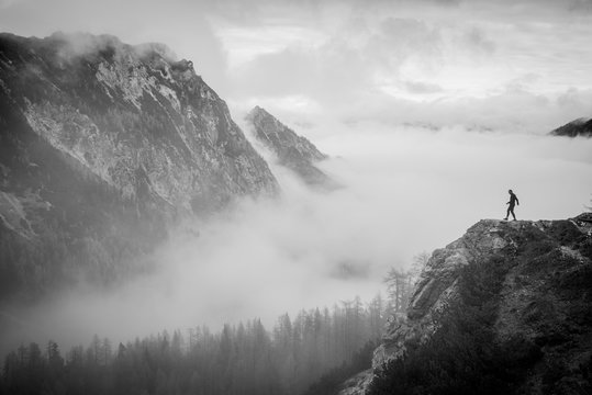 Fototapeta Tourist looking to the valley on misty autumn landscape. Black and white photo. Julian Alps, Slovenia