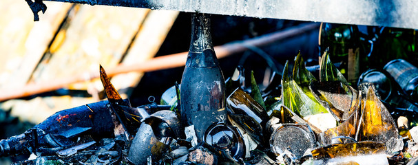 Close up Burned damaged ruins of destroyed bottles supermarket arson investigation insurance