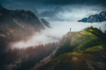 Alone tourist at the top of the hill in Alps, Italy, Europe