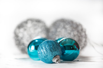 Christmas ornaments in blue and silver on white background