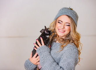 Cute dog kissing a woman - isolated over a white background. A happy pretty girl playing puppy dog.