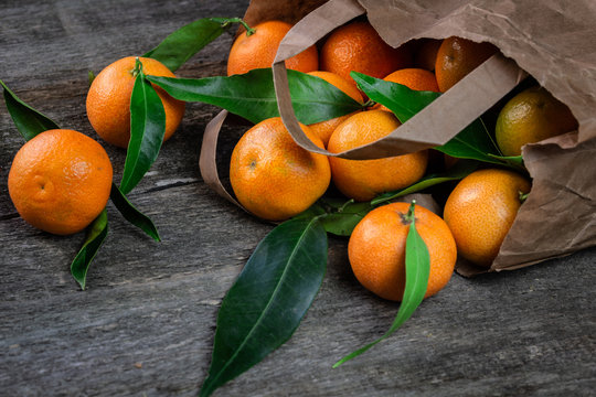 Ripe tangerines on the table. Tangerines in the package. Freshly picked