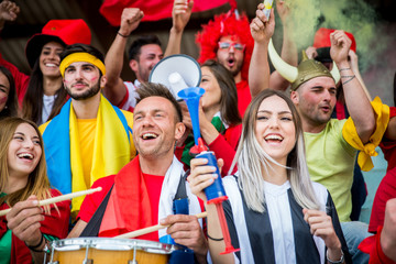 Fototapeta premium Football supporters at the stadium - Football fans having fun and looking at football match