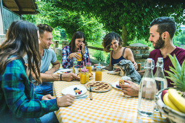 Happy friends doing breakfast in a countryhouse