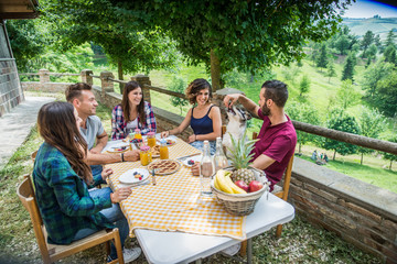 Group of friends having breakfast in a farmhouse