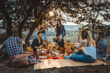 Group of friends eating in the nature