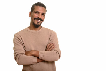 Young happy Indian man smiling with arms crossed