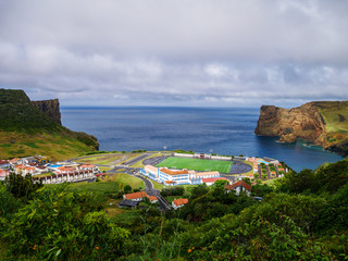 Panorama Image of soccer field and landscape next to a cliff and the atlantic sea below