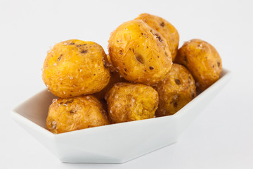 Fried yellow potato (Solanum phureja) isolated in white background